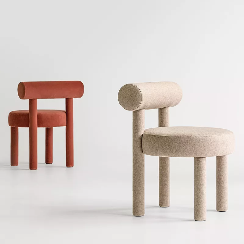 Upholstered cylindrical leg lounge chair Upholstered lounge chair with cylindrical legs and rounded seat