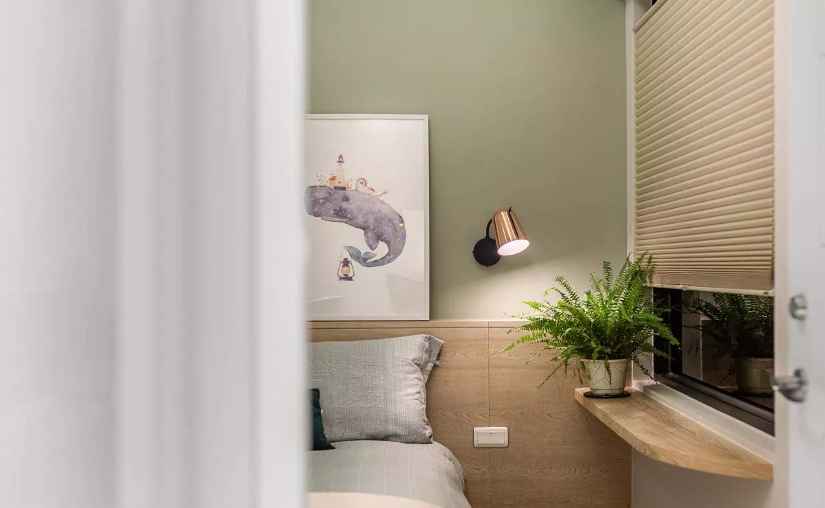 serviced apartment sleeping corner with desk and wall panel