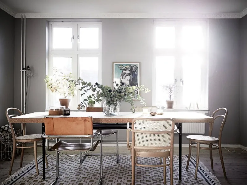 Large dining table and coordinated chairs for long-stay apartment hotel interiors